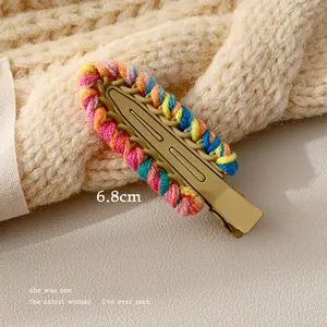 Detail of a 6.8cm colorful handmade woven yarn hair clip with a matte metal duckbill base