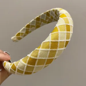 Plaid padded headband with yellow and white diamond pattern and fabric texture