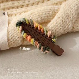 Detailed view of a 6.8cm colorful knitted wool hair clip for girls with rainbow trim