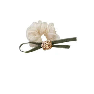 Elegant camellia organza scrunchie with dark green ribbon and golden rose detail
