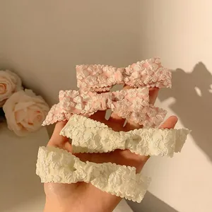 Pink and beige bow hair clips with floral texture, four-piece set for elegant styling