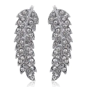 Detailed view of silver leaf-shaped crawlers with pavé set sparkling crystals on white