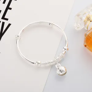 Adjustable silver bangle with hollow cylinder beads and engraved flower bell charm