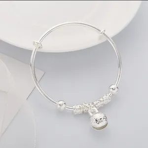 Adjustable silver baby bangle with engraved floral beads and a cartoon fish bell charm