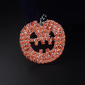 Detailed macro view of orange rhinestone pumpkin lantern brooch with sparkling smile