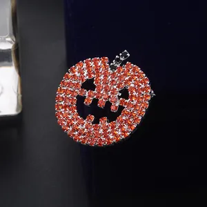 Sparkling Halloween pumpkin brooch with orange and black rhinestones on velvet box