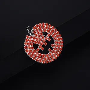Sparkling red rhinestone pumpkin brooch with Halloween Jack-o-lantern face design