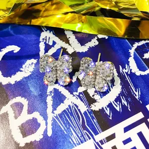 Close-up of butterfly stud earrings with silver plating and sparkling clear crystals