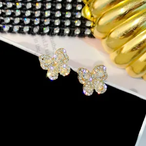 Macro view of gold butterfly stud earrings with shimmering clear cubic zirconia stones