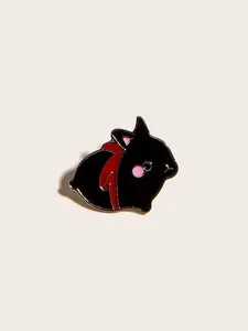 Detailed close-up of a cute black enamel rabbit brooch with a red ribbon and pink accents