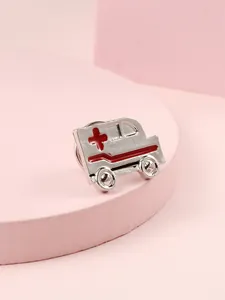 Polished silver ambulance brooch with red medical cross detail on pink stand