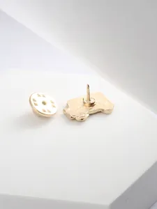 Detail view of the polished gold metal ambulance brooch back with a secure pin clasp
