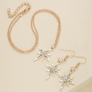 Macro detail of gold North Star jewelry set with sparkling rhinestones on double chain