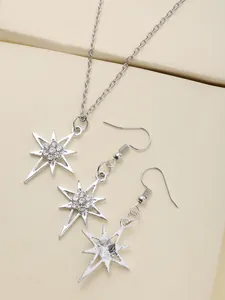 Elegant silver starburst jewelry set with sparkling rhinestones on textured display