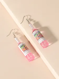 Macro shot of creative pink resin wine bottle earrings with glitter detail and silver hooks