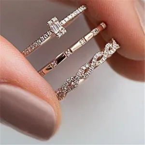 Macro detail of three rose gold rings with cubic zirconia pavé setting for layered stacking
