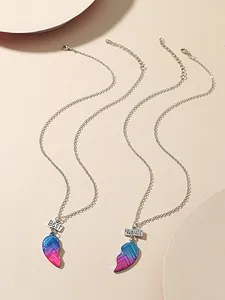 Detail of two-piece heart-shaped Best Friends necklaces with pink blue gradient enamel