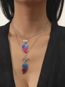 Detail of gradient heart pendants on silver chains with BEST FRIENDS lettering