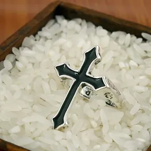 Macro shot of gothic cross ring with black enamel inlay on antique silver finish