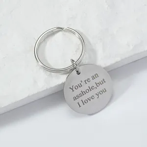 Polished stainless steel round keychain engraved with romantic humorous message on stone