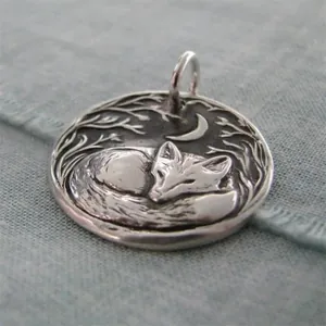 Vintage silver crescent moon and sleeping fox pendant with intricate forest relief