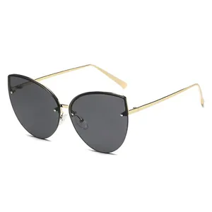 Chic oversized cat-eye sunglasses with gold metal frames and dark lenses for women