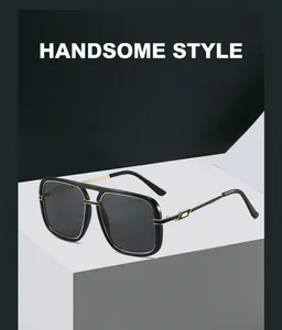 Detail of oversized square sunglasses with gold metal trim on a minimalist display