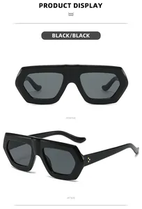 Detail view of bold hexagonal black frame sunglasses with metallic triple-dot rivet accents