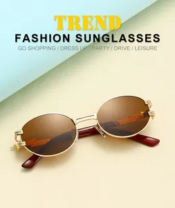Detail of gold metal oval sunglasses with brown lenses and lightning design elements
