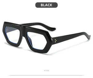 Side view of chunky black hexagonal sunglasses with blue lenses and gold rivets
