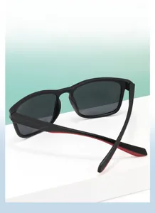 Detail view of square matte black sunglasses with contrasting red inner temples and polarized lens