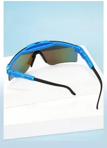 Detail of blue outdoor sports goggles with yellow ink splash texture and colorful lens