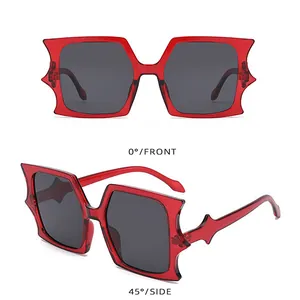 Detailed front and side views of irregular bat-wing shaped sunglasses in transparent red
