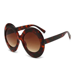 Oversized oval sunglasses with tortoiseshell frames and brown gradient lenses