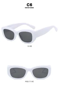 Detail view of white retro sunglasses with dark grey lenses and anti-slip side arms