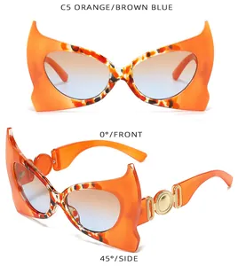 Occhiali da sole cat-eye arancioni con trama tartarugata e lenti sfumate blu e arancioni