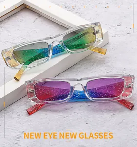Detail of transparent rectangle glitter sunglasses with vibrant gradient lenses and silver flakes