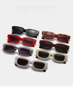 Flat lay display of retro rectangle sunglasses in seven colors with dark lenses