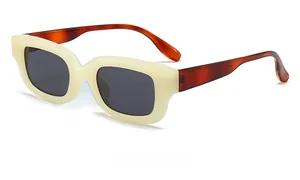 Side view of retro cream sunglasses with tortoiseshell temples and dark lenses