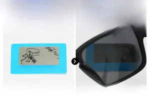 Close-up of polarized sunglasses showing fish pattern on test card for glare reduction