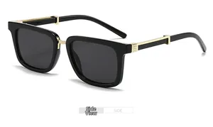 Side view of square black sunglasses with elegant gold metal hinge and grey lenses