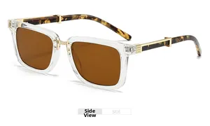 Side view of square sunglasses with clear frame, tortoiseshell temples and gold hinges
