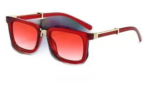 Side view of square oversized red sunglasses with gradient lenses and gold metal accents