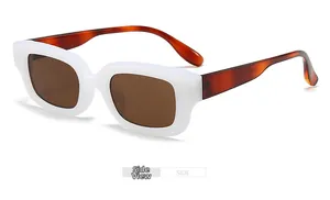 Side view of white thick frame sunglasses with brown lenses and tortoiseshell temples