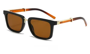Side view of square sunglasses with amber lenses and gold-toned metal temples