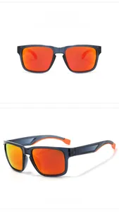 Close-up of grey-blue frame sports sunglasses with orange temples and red polarized lenses