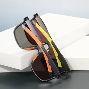 Polarized sports sunglasses with orange and yellow temples on a white geometric stand