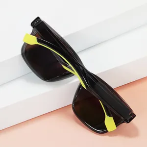 Polarized sports sunglasses with black translucent frame and neon green accents