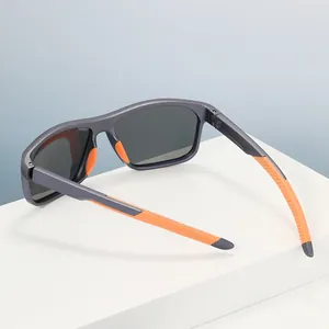 Polarized sports sunglasses with matte grey frame and orange anti-slip pads on white stand