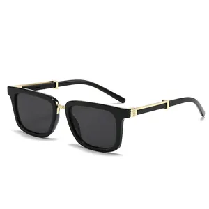 Modern square black sunglasses with gold metal accents and dark UV protective lenses